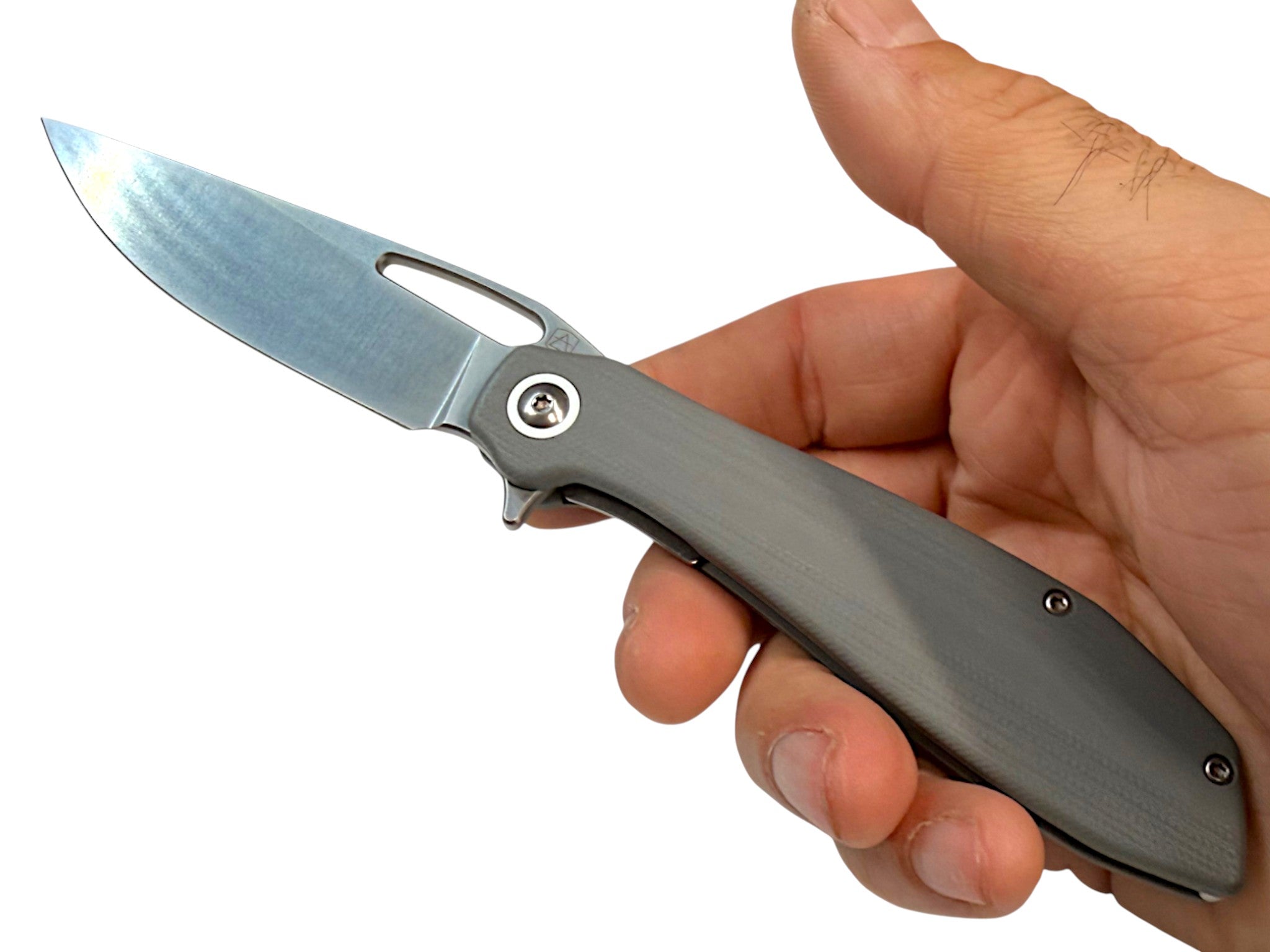 CountyComm Exclusive BXTR folding knife with semi-polished 8Cr13MoV steel blade and grey G10 handle, held in hand.