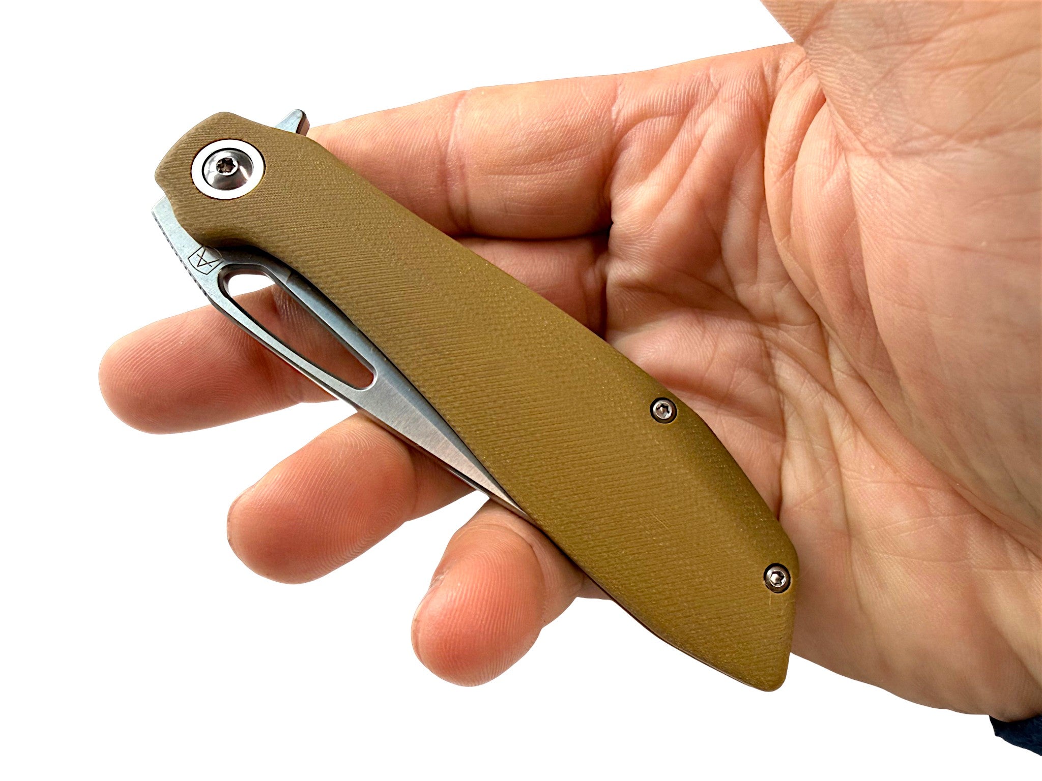 CountyComm BXTR folding knife with a tan G10 handle and semi-polished 8Cr13MoV steel blade, held in a hand.