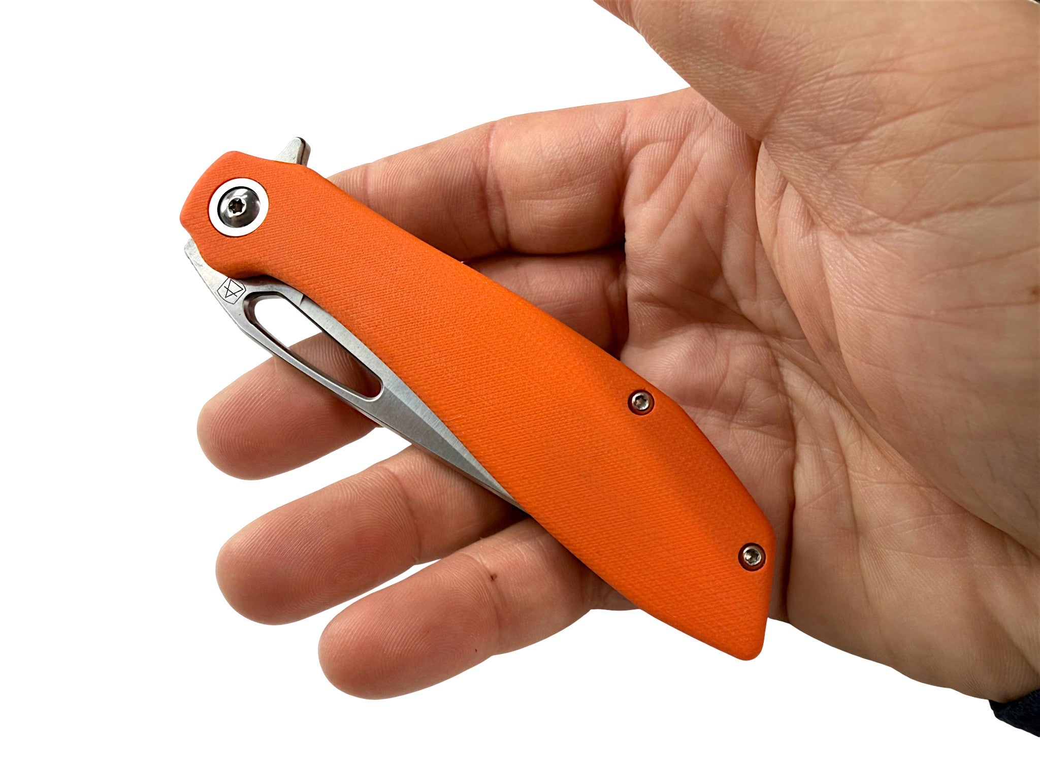 CountyComm orange G10 handle folding knife with semi-polished steel blade, held in hand.